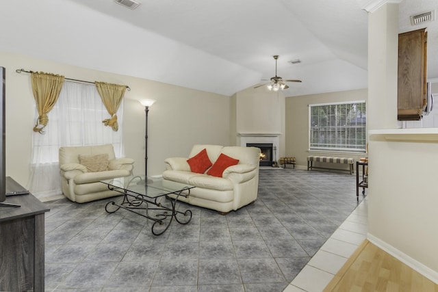 living room with ceiling fan and vaulted ceiling