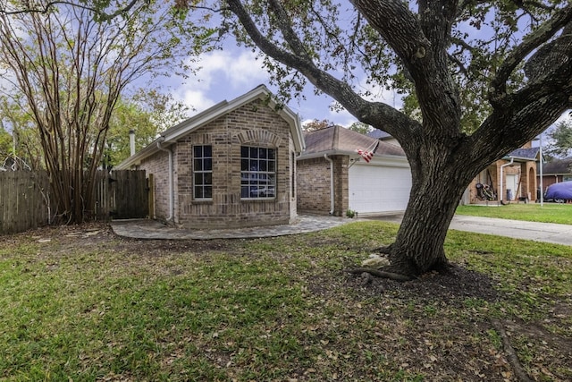 view of front of property with brick siding, fence, driveway, and an attached garage