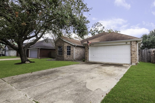 single story home with brick siding, an attached garage, fence, driveway, and a front lawn