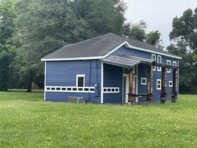 exterior space with a lawn and cooling unit