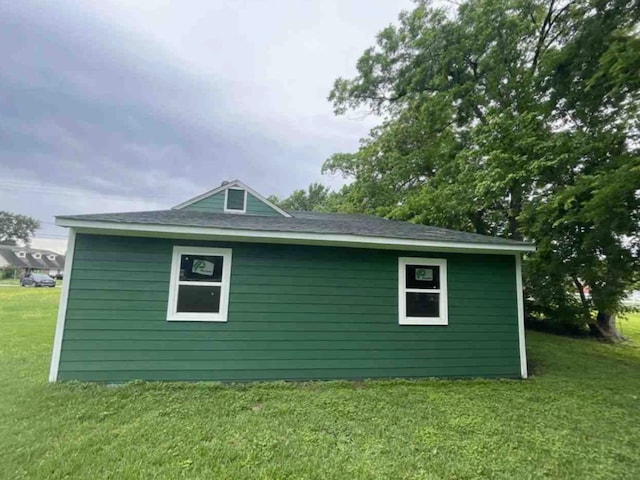 view of side of home featuring a lawn