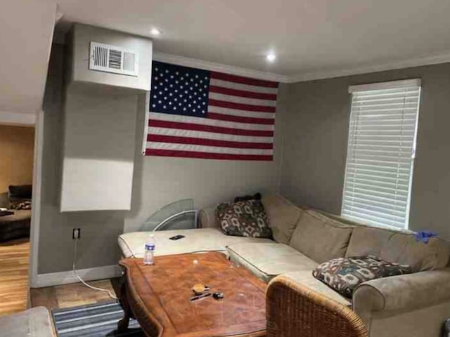 living room featuring wood-type flooring and crown molding