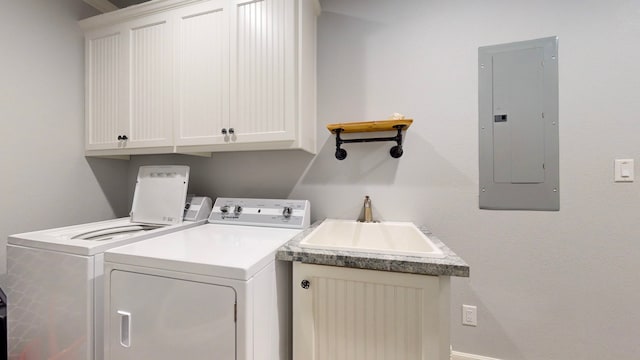 laundry room with cabinets, independent washer and dryer, electric panel, and sink