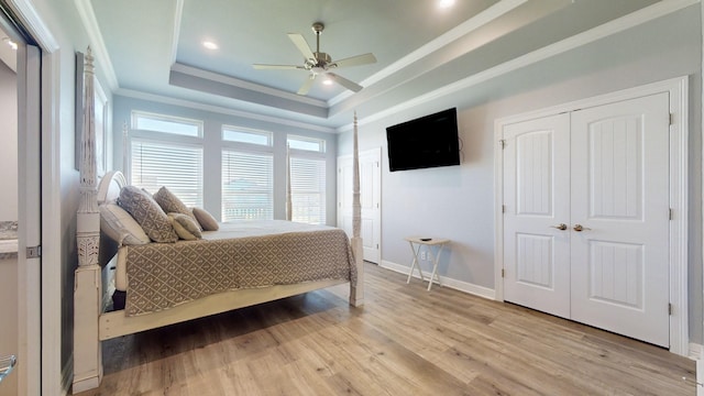 1819 Redfish Ln, Crystal Beach, TX 77650 - bedroom with a raised ceiling, crown molding, light wood-type flooring, baseboards, and a ceiling fan
