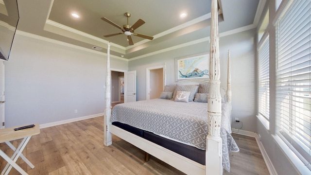 1819 Redfish Ln, Crystal Beach, TX 77650 - bedroom with light wood-style floors, ornamental molding, a tray ceiling, baseboards, and a ceiling fan