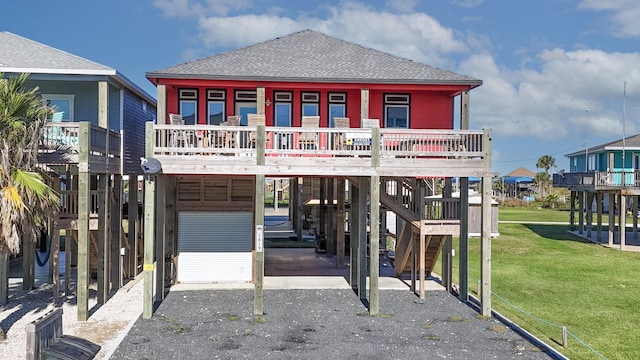 1819 Redfish Ln, Crystal Beach, TX 77650 - view of front of home featuring a carport, driveway, roof with shingles, a front lawn, and stairs