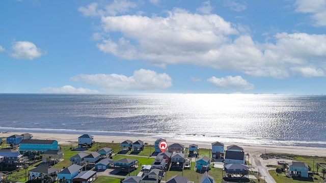 birds eye view of property featuring a beach view and a water view