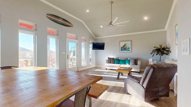 living room with light wood-type flooring, vaulted ceiling, ceiling fan, and ornamental molding