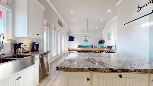 1819 Redfish Ln, Crystal Beach, TX 77650 - kitchen featuring stainless steel dishwasher, crown molding, light wood-type flooring, tasteful backsplash, and a ceiling fan