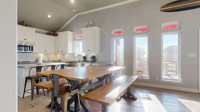 1819 Redfish Ln, Crystal Beach, TX 77650 - dining room with lofted ceiling, crown molding, light wood-style floors, recessed lighting, and baseboards