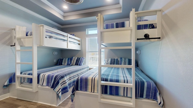 1819 Redfish Ln, Crystal Beach, TX 77650 - bedroom featuring wood finished floors, crown molding, a tray ceiling, and baseboards