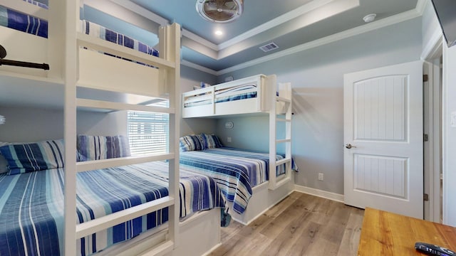 1819 Redfish Ln, Crystal Beach, TX 77650 - bedroom featuring ornamental molding, wood finished floors, baseboards, and a raised ceiling