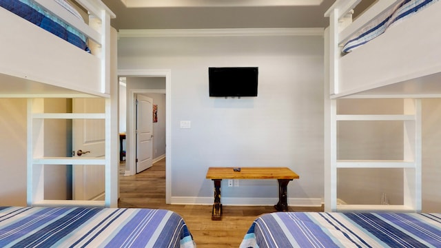 bedroom with wood-type flooring and ornamental molding