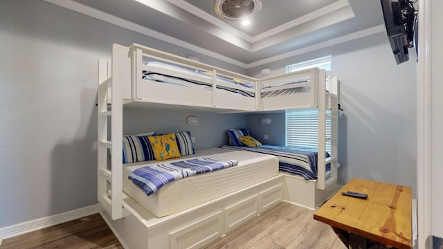 1819 Redfish Ln, Crystal Beach, TX 77650 - bedroom with light wood-style flooring, ornamental molding, a tray ceiling, and multiple windows
