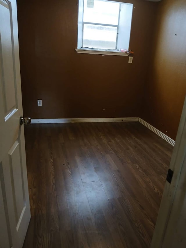 empty room featuring dark hardwood / wood-style flooring