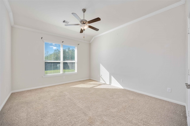 empty room featuring ceiling fan, ornamental molding, and light carpet