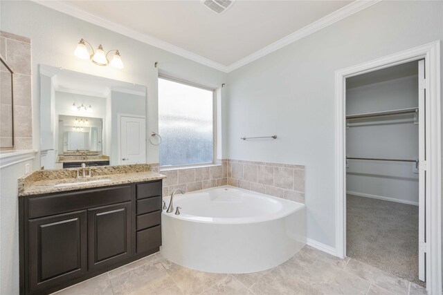 bathroom featuring a washtub, vanity, tile patterned floors, and ornamental molding