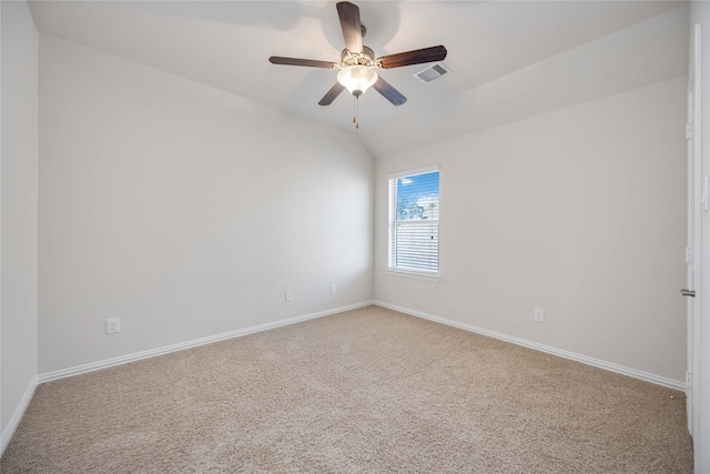 carpeted empty room with ceiling fan and vaulted ceiling