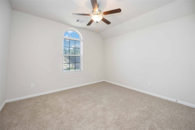 carpeted spare room featuring ceiling fan and lofted ceiling