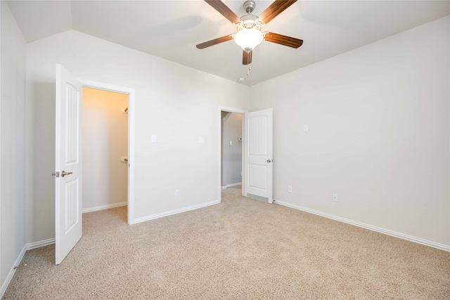 unfurnished bedroom with light carpet, ceiling fan, and lofted ceiling