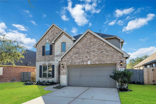 view of front property featuring a garage and a front yard