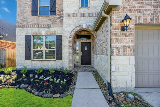 view of exterior entry with a garage