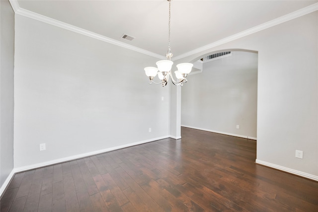 empty room featuring dark hardwood / wood-style floors, ornamental molding, and a notable chandelier