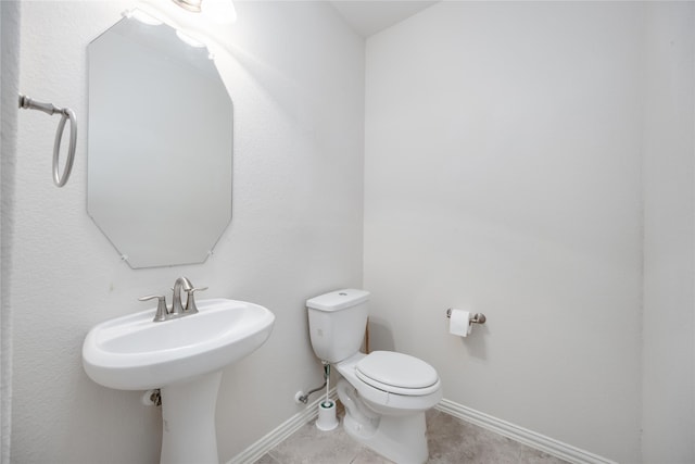 bathroom with tile patterned flooring and toilet