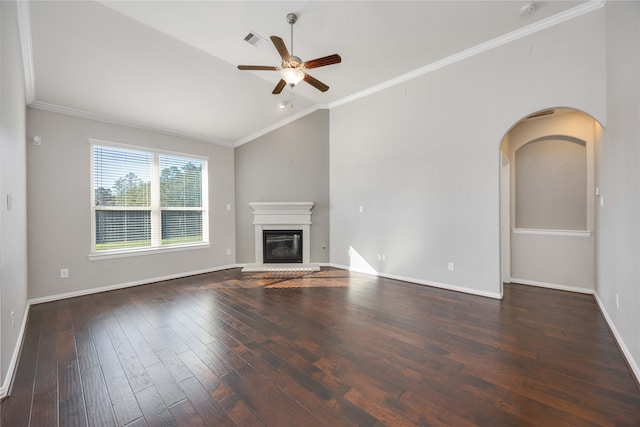 unfurnished living room with ceiling fan, ornamental molding, dark wood-type flooring, and vaulted ceiling