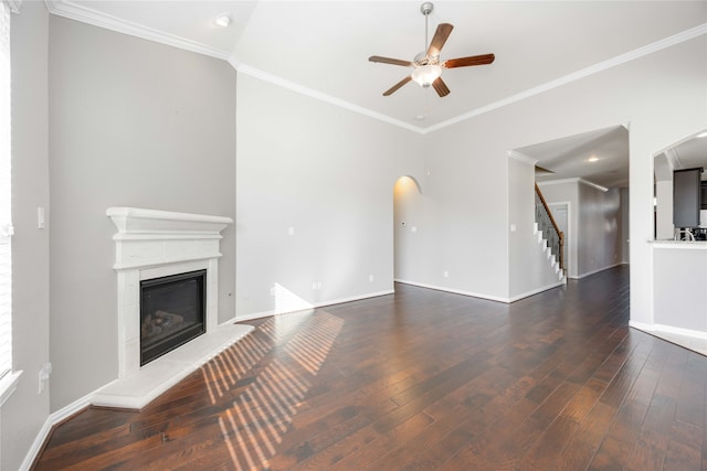 unfurnished living room with dark hardwood / wood-style flooring, ceiling fan, and ornamental molding