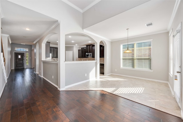 entryway with ornamental molding and dark wood-type flooring