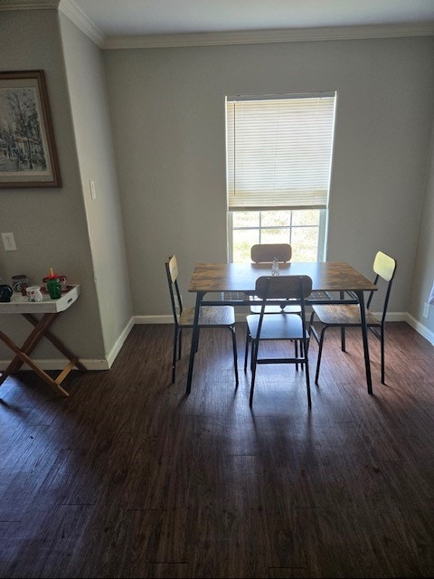 dining room featuring dark wood-type flooring and ornamental molding