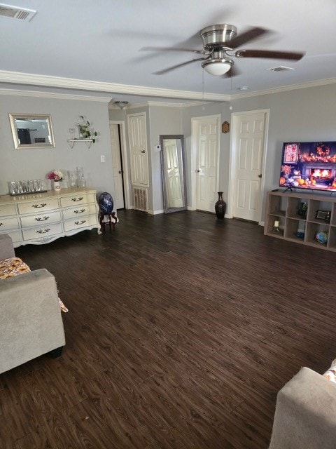 living room featuring dark hardwood / wood-style flooring, ceiling fan, and ornamental molding