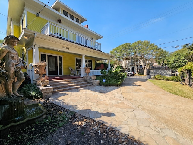 view of front of house featuring covered porch and a balcony