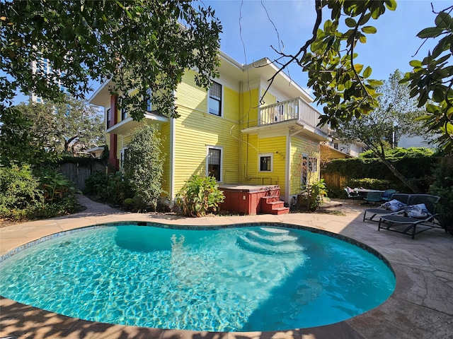 view of pool featuring a patio and a hot tub