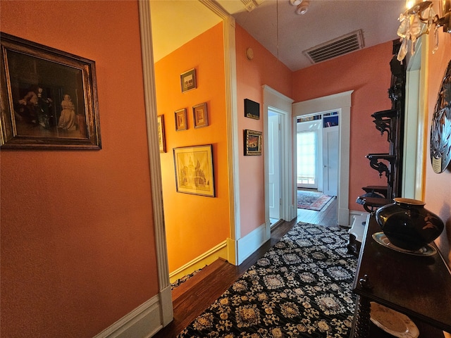 hallway with dark hardwood / wood-style flooring