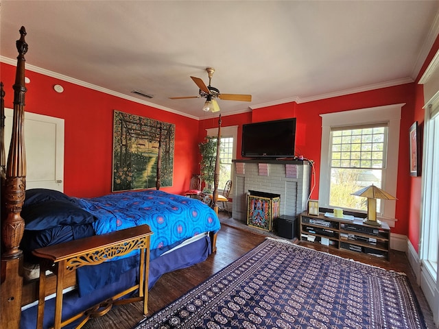 bedroom with ceiling fan, crown molding, and wood-type flooring