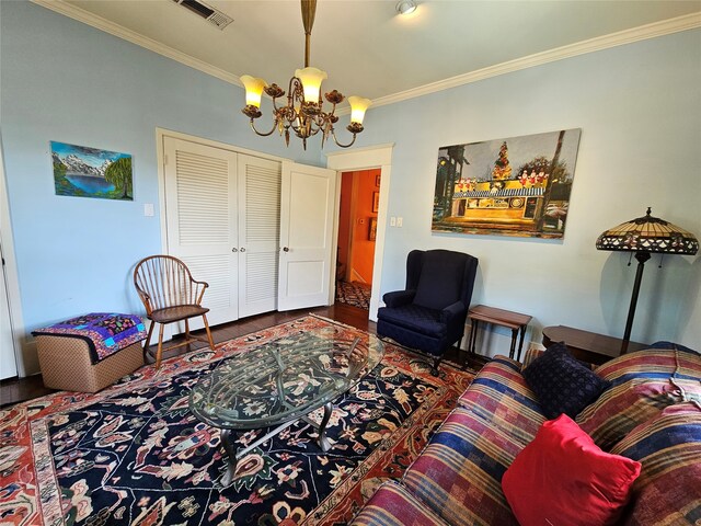 living room with crown molding, a chandelier, and hardwood / wood-style flooring