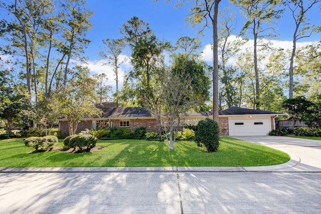 ranch-style home with a garage and a front lawn