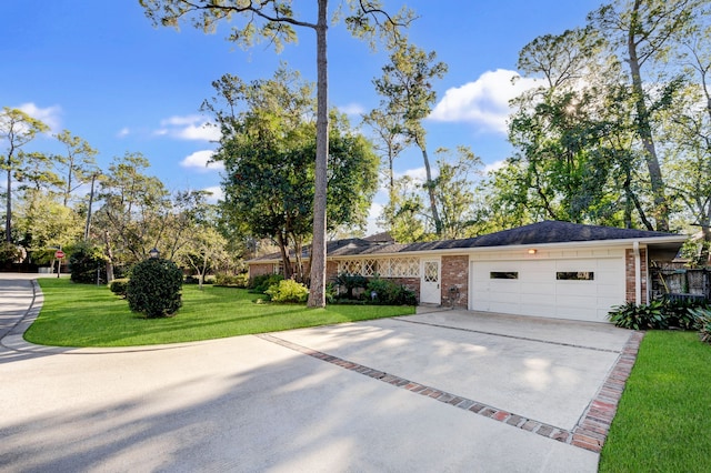 single story home featuring a front lawn and a garage