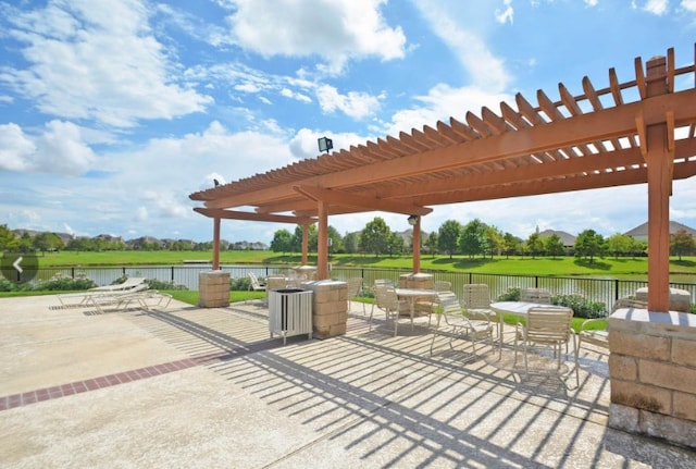 view of patio / terrace featuring a pergola and a water view