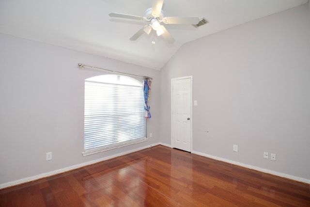 spare room with ceiling fan, wood-type flooring, and vaulted ceiling