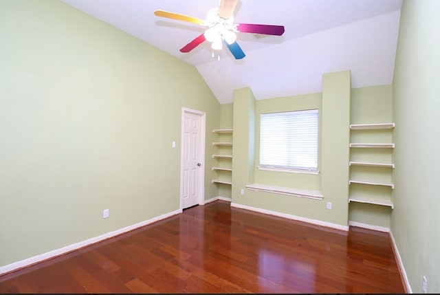 unfurnished room featuring ceiling fan, dark wood-type flooring, and lofted ceiling