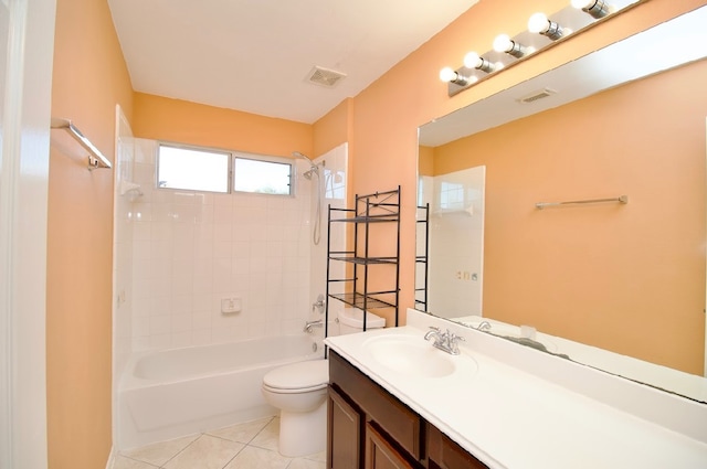 full bathroom featuring tile patterned floors, vanity, toilet, and tiled shower / bath