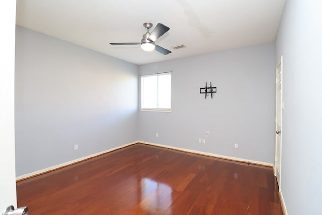 spare room with hardwood / wood-style floors and ceiling fan