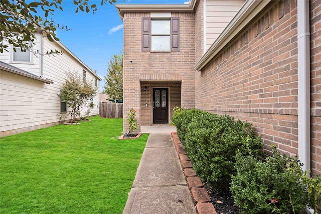 doorway to property with a lawn