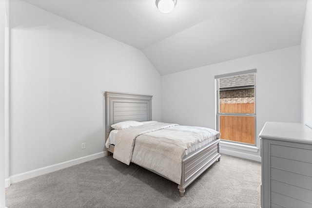 carpeted bedroom with lofted ceiling