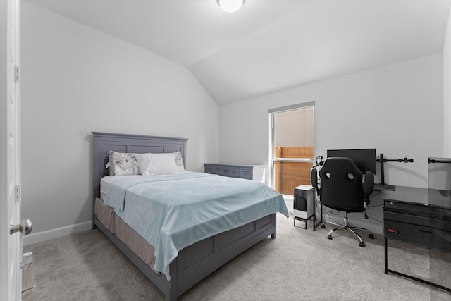 carpeted bedroom featuring lofted ceiling