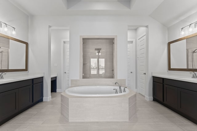 bathroom with tile patterned flooring, vanity, and separate shower and tub