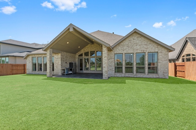 rear view of house with a patio area and a yard